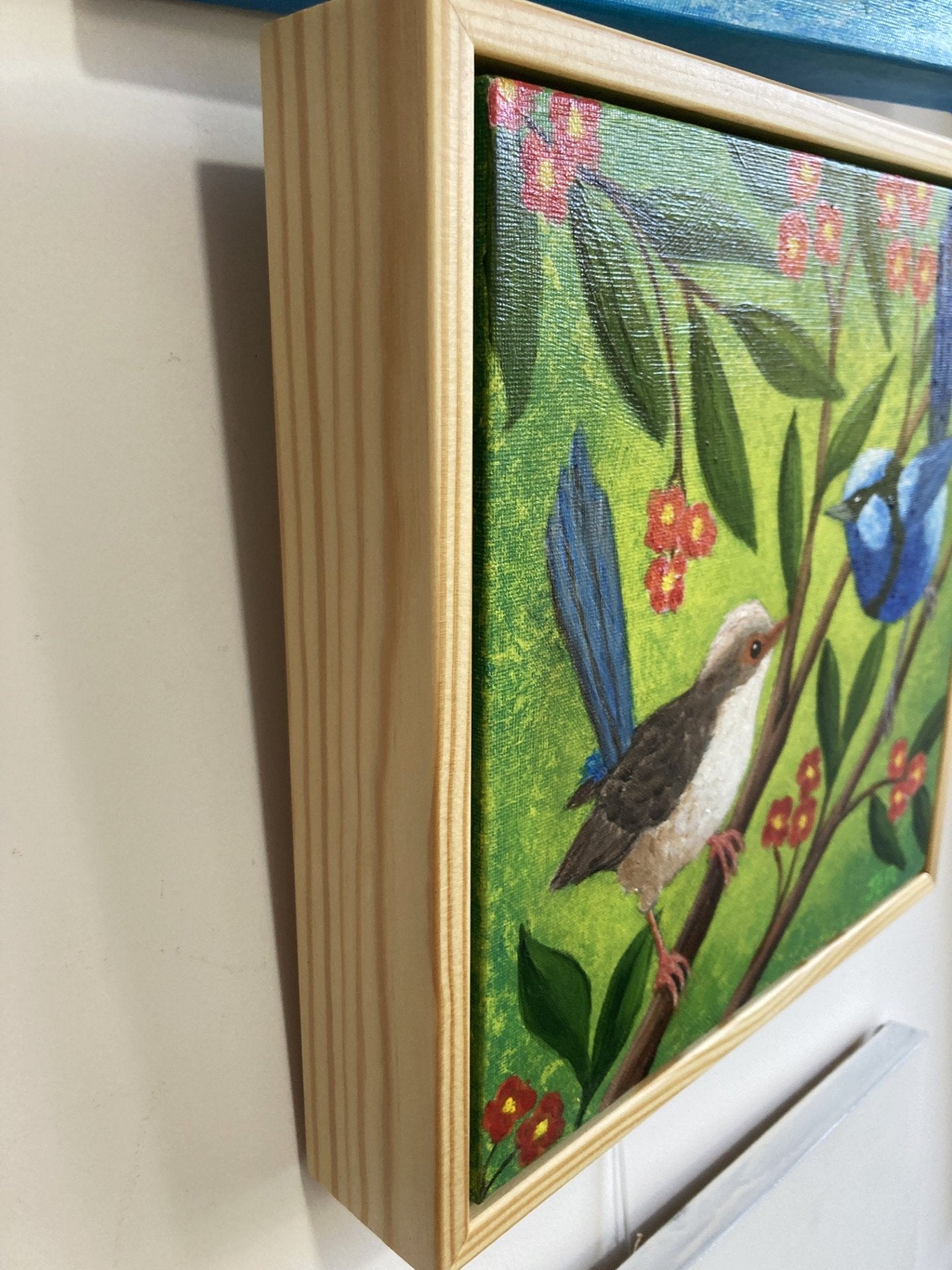 69164a62e1b8ea140711df10_blue-wrens-framed-side_1779585785370.jpg