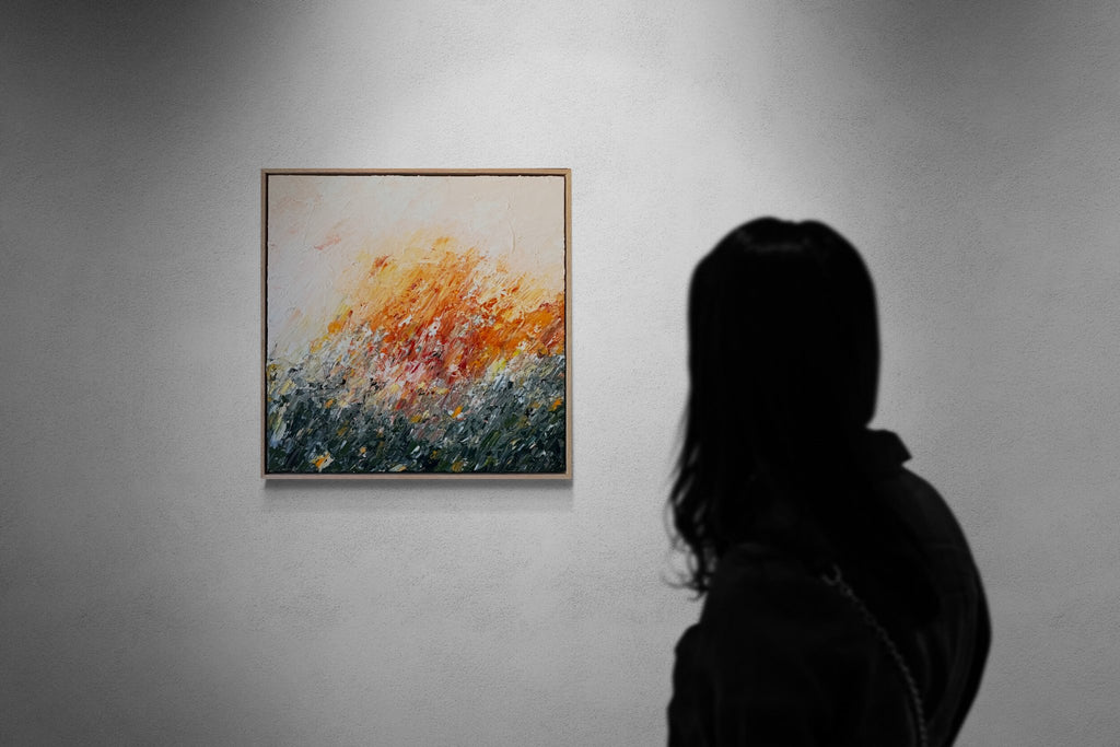 69164a62e1b8ea140711df10_woman-looking-at-gallery-wall-3_1790476718243.jpg